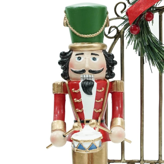 Schiaccianoci Natalizi in Resina con Cancello in Ferro H.22,5 cm